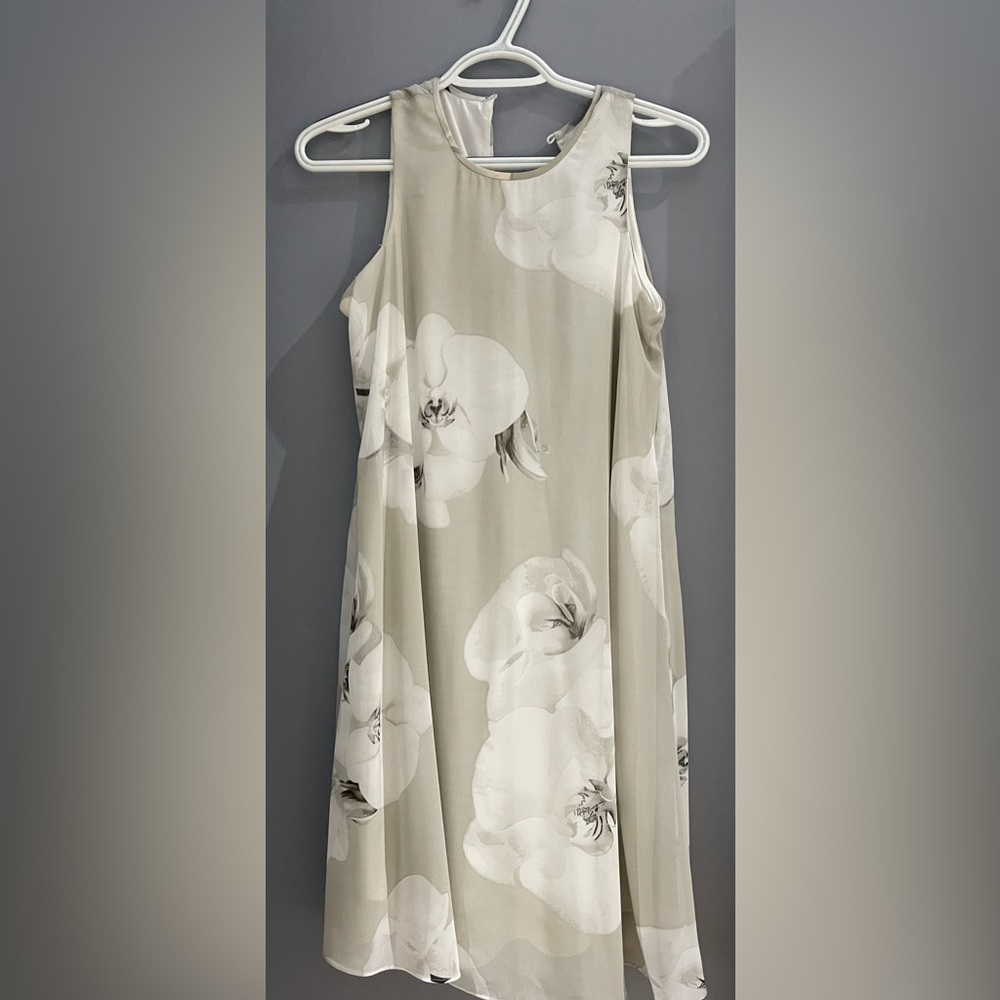 Calvin Klein shear white floral dress. Asymmetrical dress. Button clasp.